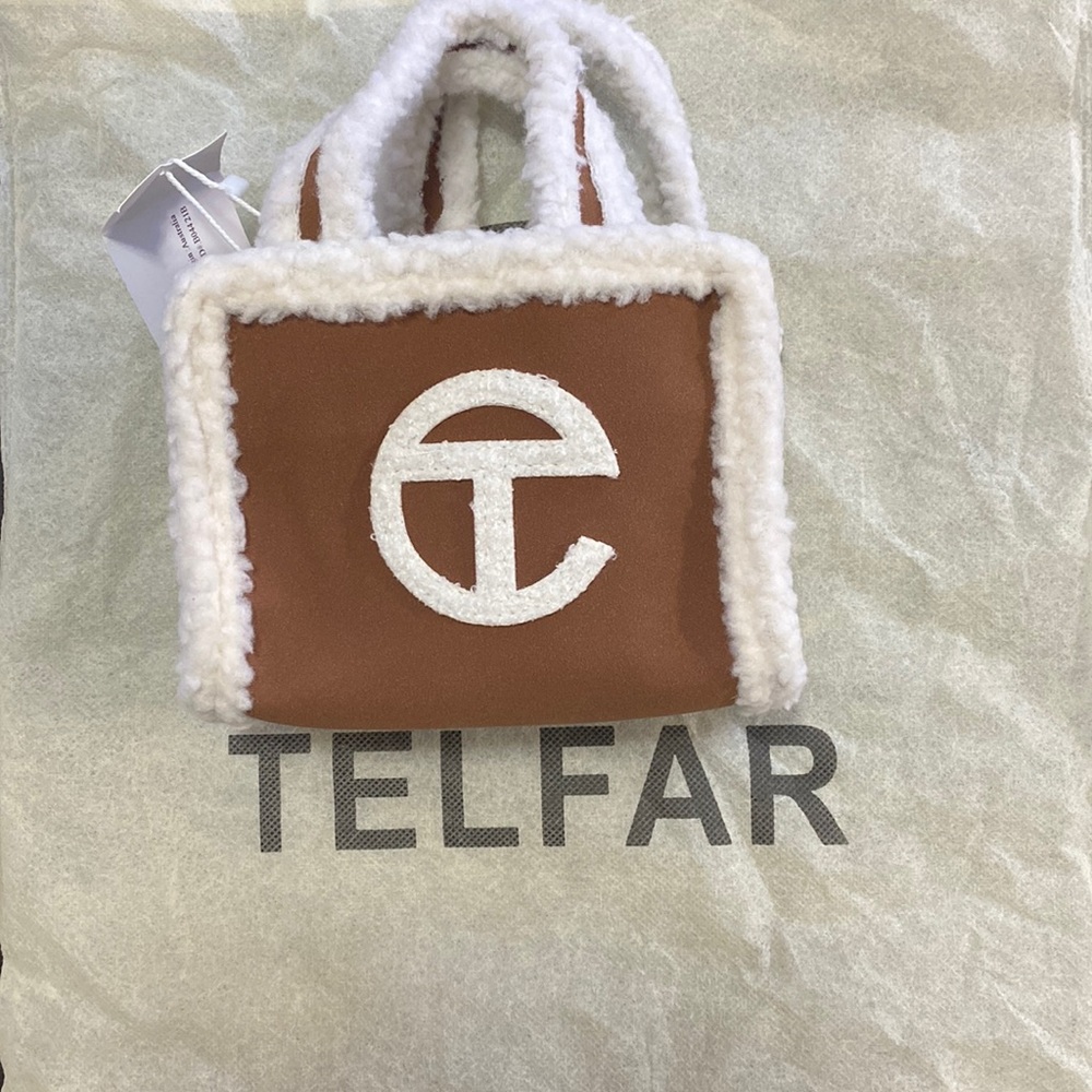 Ugg and Telfar small purse with hand and shoulder strap.